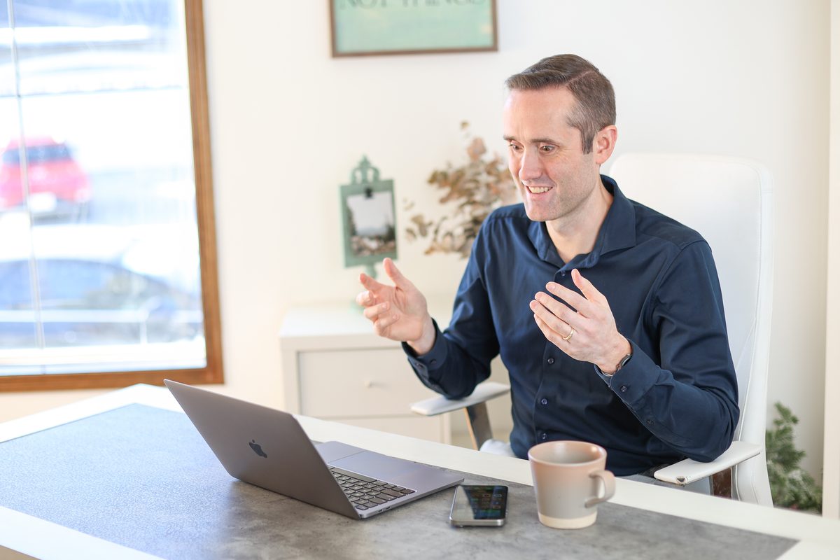 Josh Tagg at his desk helping a client